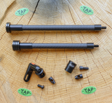 TAP-DOA ULTRA-Light stabilizers for archery in black, showcasing their sleek design and lightweight construction on a wooden surface
