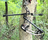 TAP Side Stabilizer Mount with titanium screws attached to a bow in a wooded setting, featuring 7075-T6 aluminum construction for enhanced archery stabilizer mount performance.