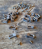 Collection of PSE bow draw stops in titanium with screws, designed for improved archery performance and control